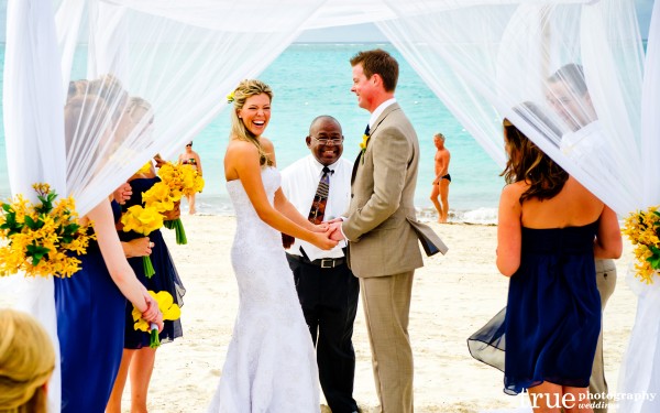 San Diego Wedding Photographer: Destination wedding on the beach in Turks and Caicos bride laughing during ceremony