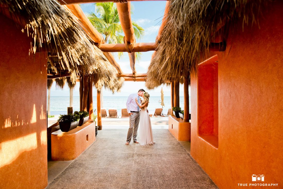 Photograph of bride and groom kissing at a destination wedding. Leading lines add emphasis to the couple.