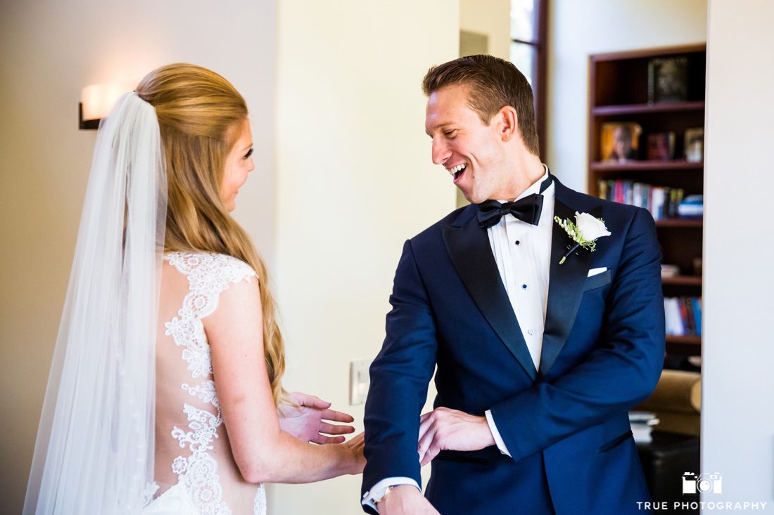 Happy groom seeing Bride for the first time in a stylish navy tuxedo