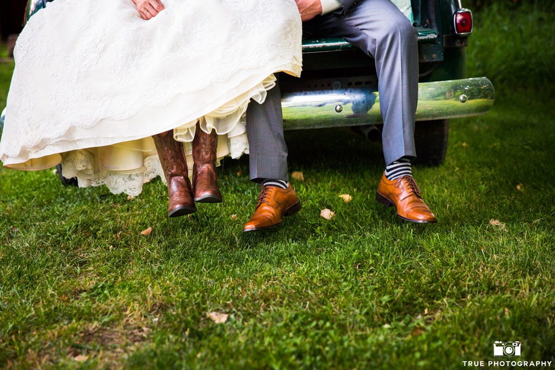 Bride wearing cowboy boots and groom wearing brown dress shoes