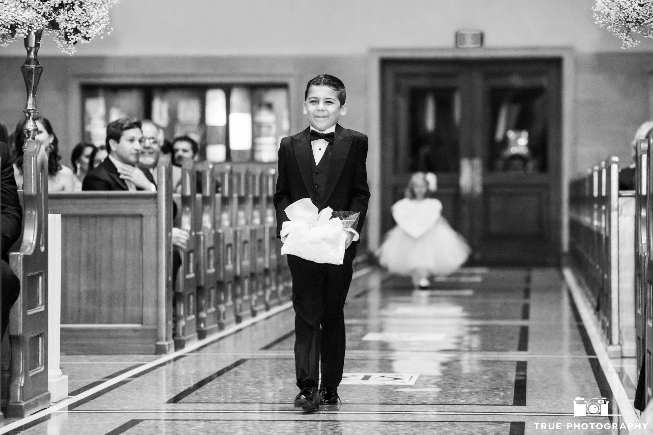 b&w of ring bearer with flower girl behind