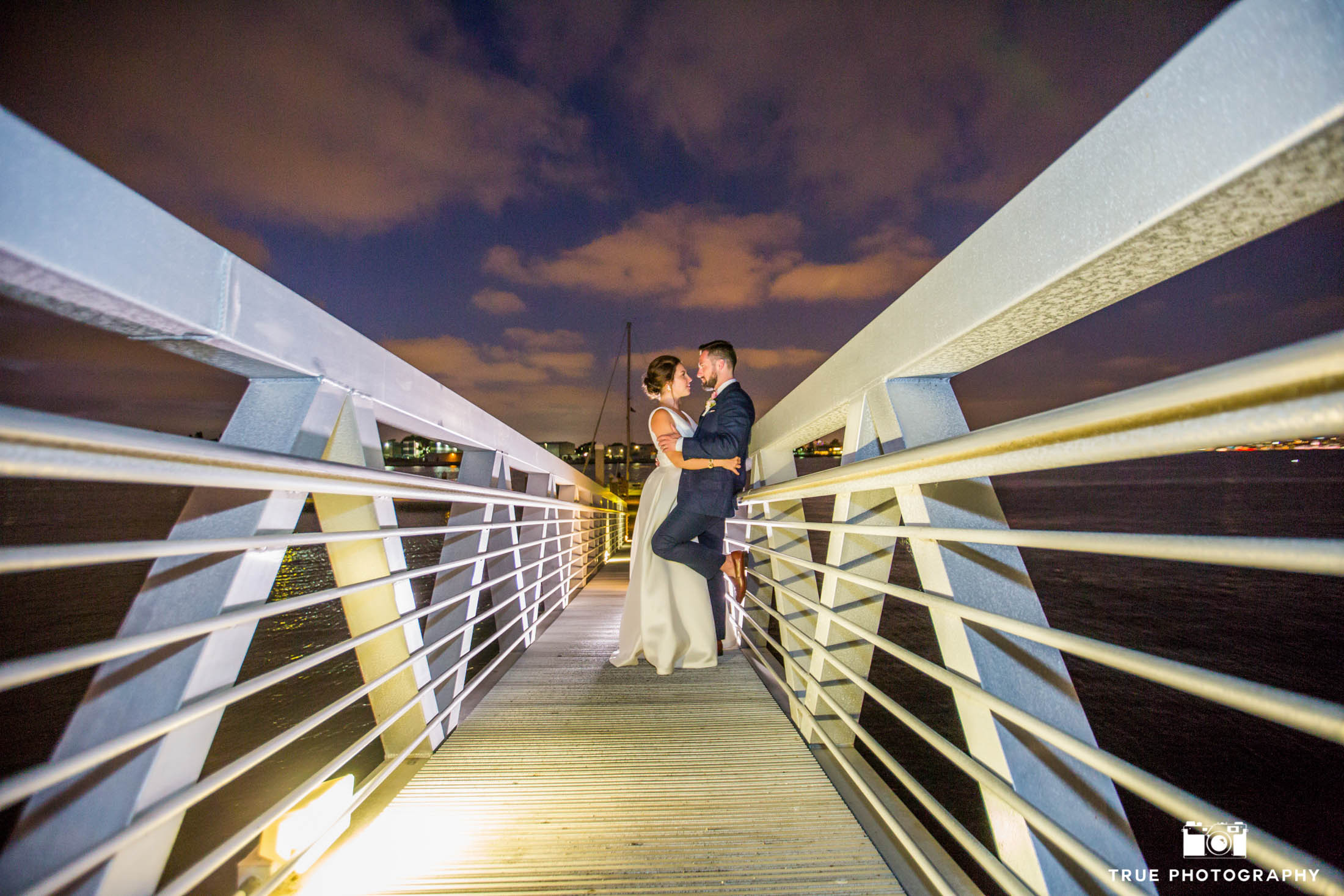 Night photography of bride and groom on a pier